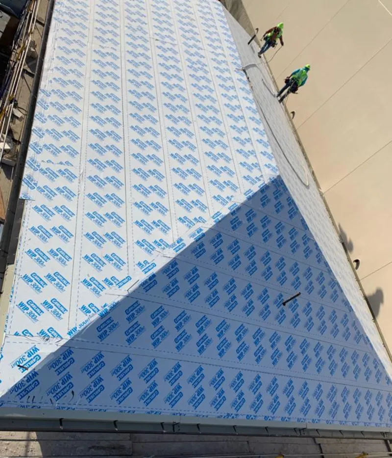 Professional roofers installing underlayment on a metal roof in Alamogordo